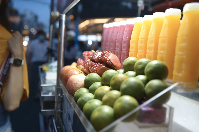 a display of fruits and juices at a market
